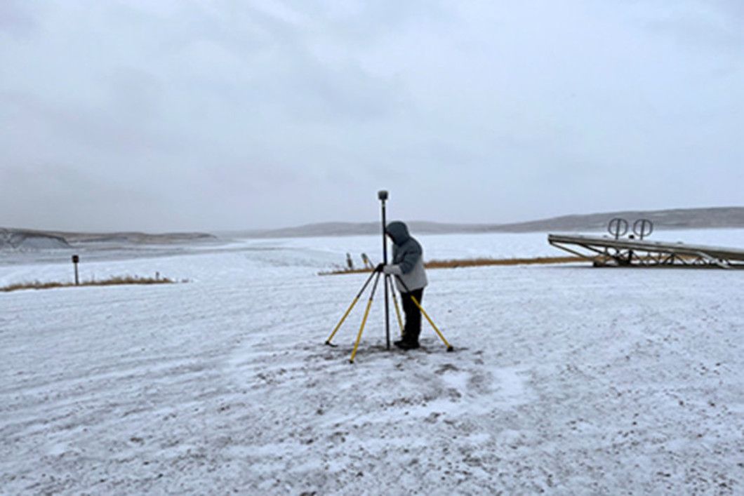 Surveyor in a remote, rugged landscap